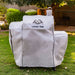 White Laredo 1000 grill cover on grass.