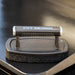 Black Pit Boss grill cleaning tool with textured handle and sponge pad.