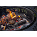 Round metal fire pit with burning logs and flames, mesh sides, and PIT BOSS branding visible on the rim.