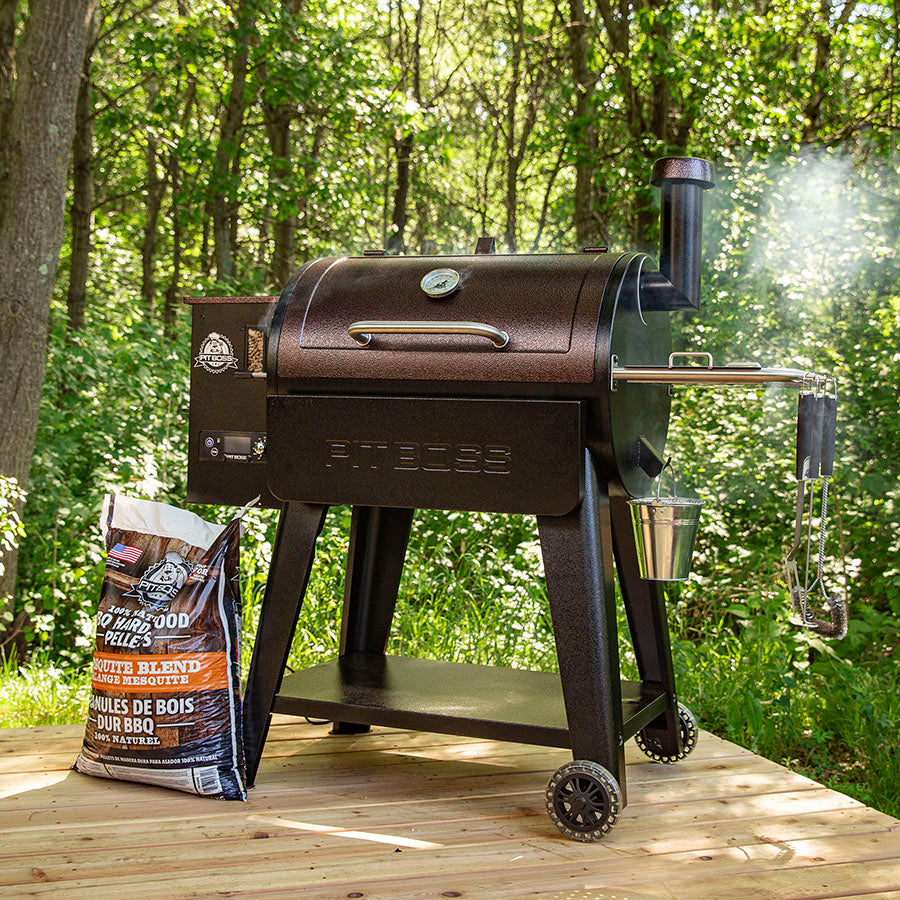Brown Pit Boss pellet grill with smoker box and wood pellets bag.