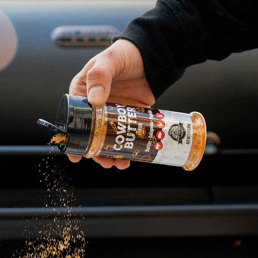 Cowboy Butter Rub seasoning container being shaken, showing label details.