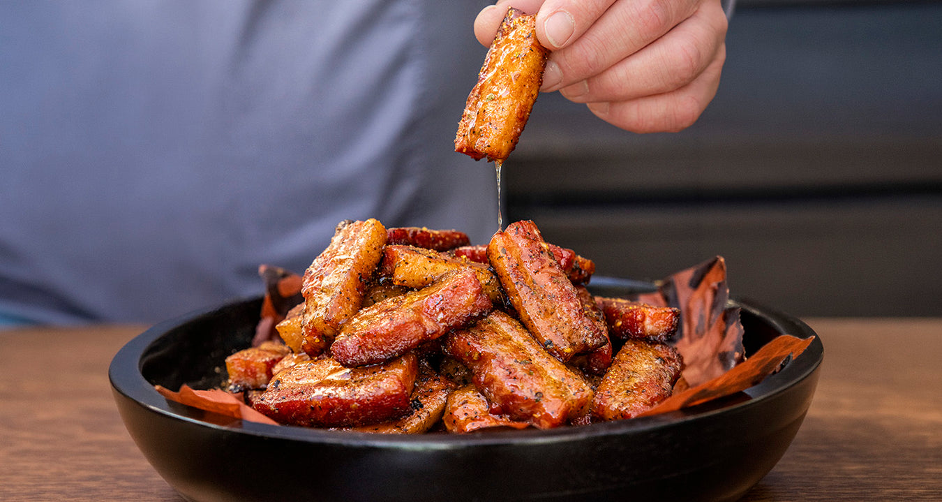 candied pork belly BBQ appetizer smoked on pit boss wood pellet grill served in black bowl