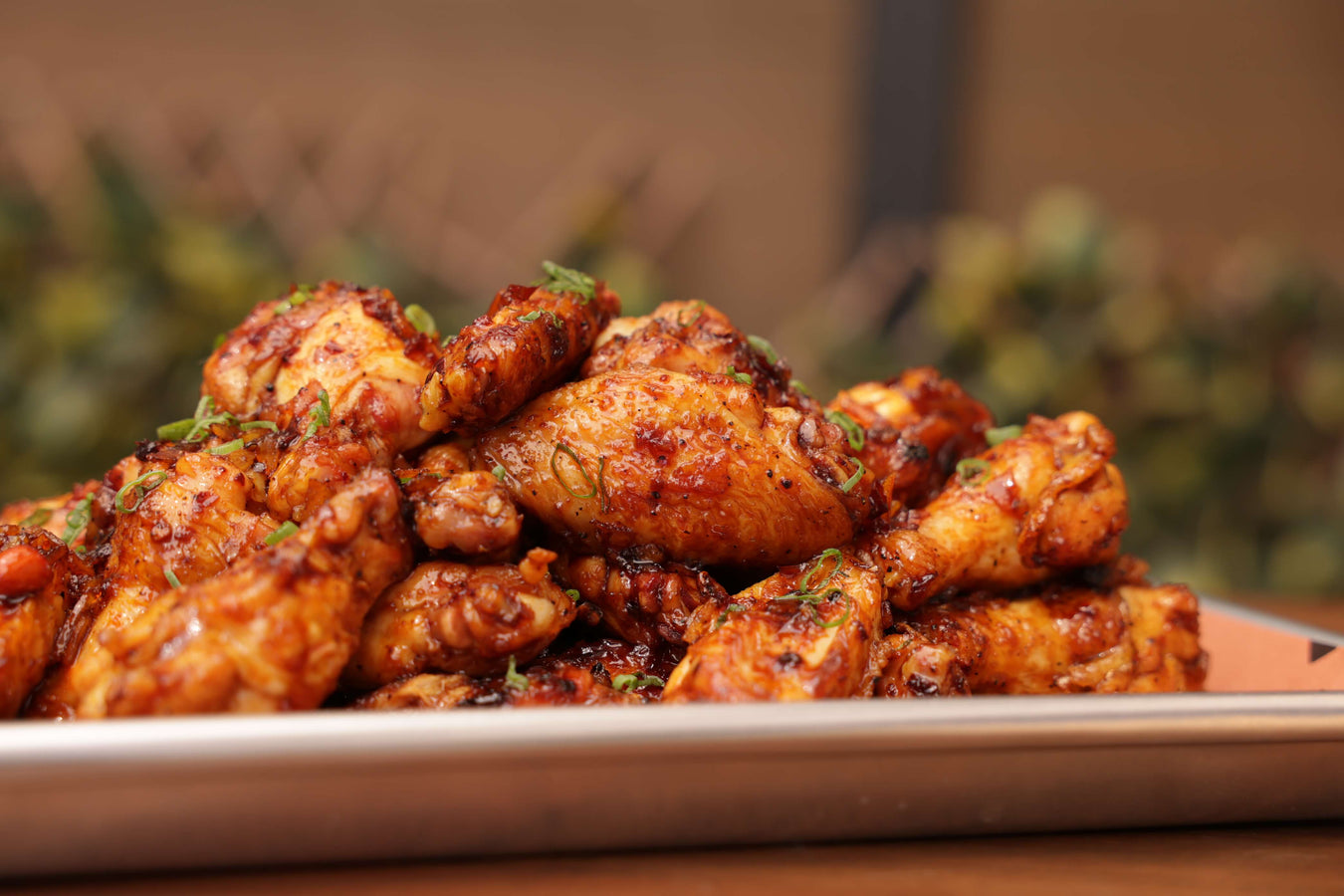 grilled wings coated in homemade chili orange glaze served on aluminum tray