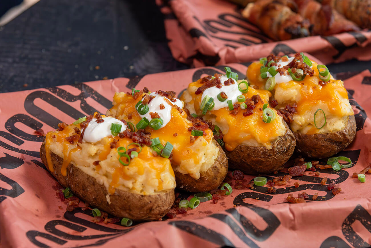twice baked potatoes cooked on pellet grill with cheese and bacon served on bbq butcher paper
