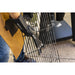 Close up of man carrying grilling rack with Pit Boss gloves and ash broom.