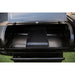 Black grill with open lid, showing cooking grates and warming rack.