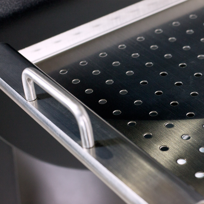 Stainless steel perforated drawer organizer with silver handle.