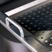 Stainless steel perforated drawer organizer with silver handle.