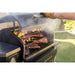 Green Camp Chef Series portable charcoal grill with food cooking.