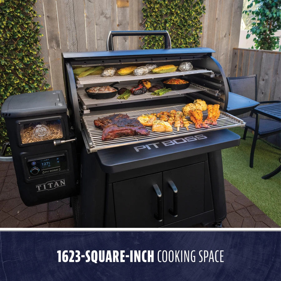 Black Pit Boss Titan grill with 1623-square-inch cooking space, displaying various grilled foods.