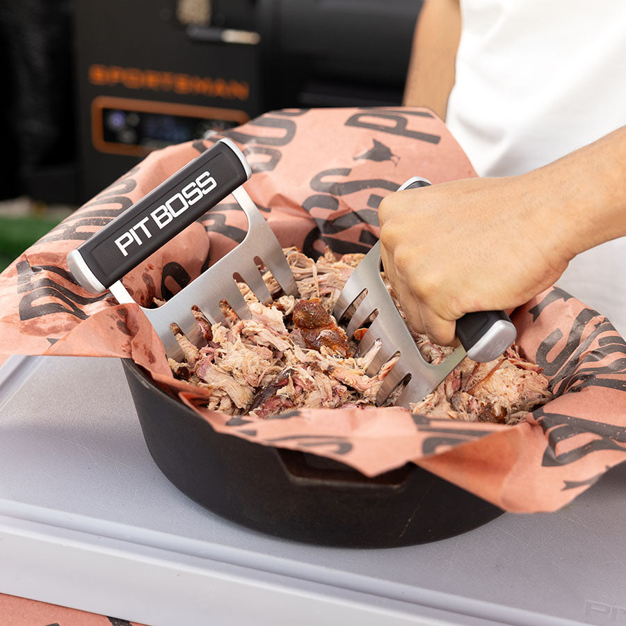 Black Pit Boss shredding tool for pulled pork in a bowl.