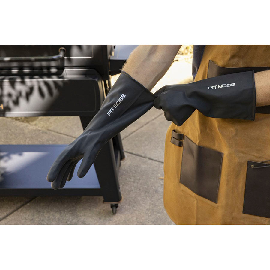 Close up of man putting ll black with white Pit Boss name logo gloves on outside.