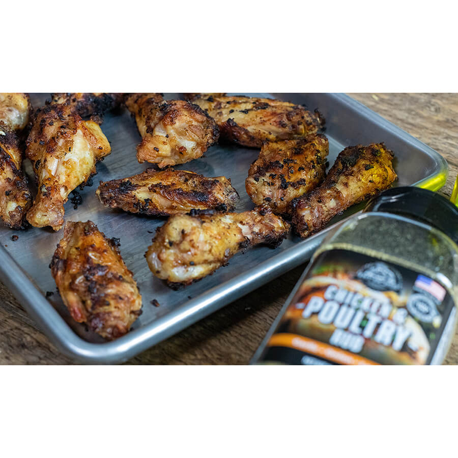 "Blackened chicken wings on tray with McCormick Chicken & Poultry Rub bottle."