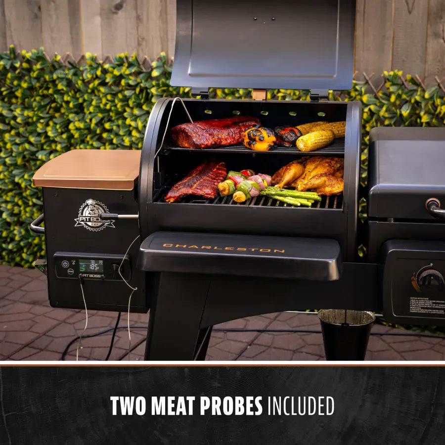 Black Pit Boss Charleston pellet grill with two meat probes included, cooking meats and vegetables.