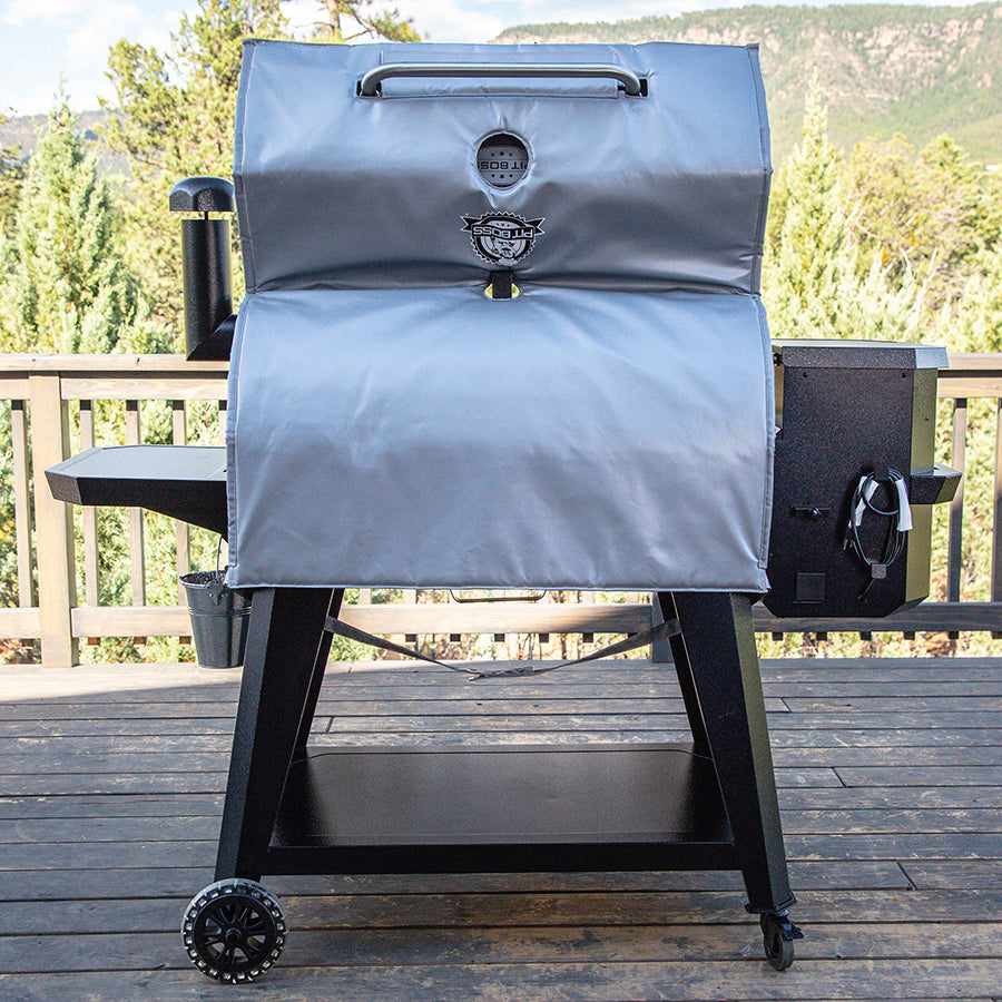 Gray Pellet Grill with black legs and wheels, outdoor setting.