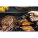 Black RT808S digital meat thermometer measuring temperature on grilled meat and sweet potatoes.