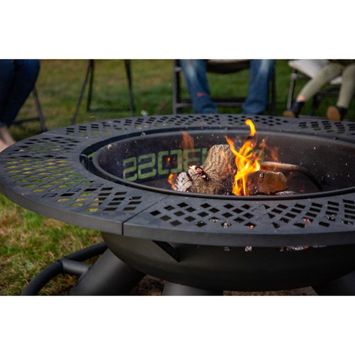 lifestyle_1, Black fire pit with round shape and black lettering: Pit Boss. Close up f inside of fire pit with active fire
