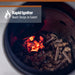 Rapid Igniter charcoal starter with glowing coals inside a black container.
