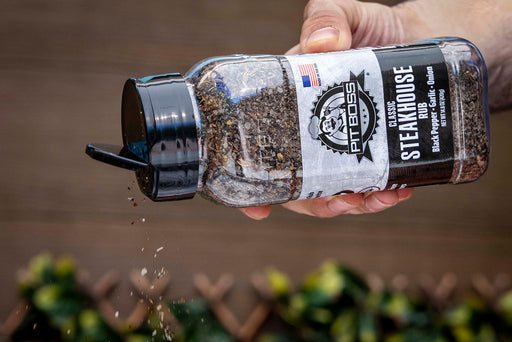 Clear glass bottle of Pit Boss Classic Steakhouse Rub with black lid.