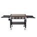 "Black and stainless steel Pit Boss griddle with four burners and side shelves on wheels."