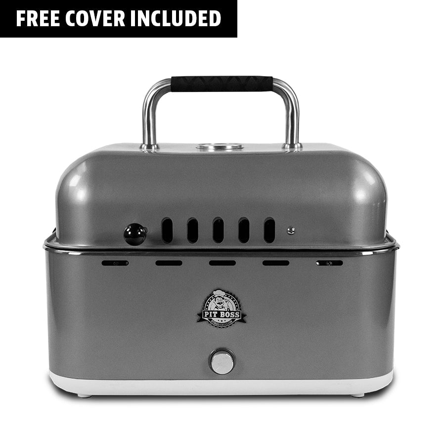 Compact silver Pit Boss portable grill with handle, front vents, and free cover included. Ideal for outdoor cooking.
