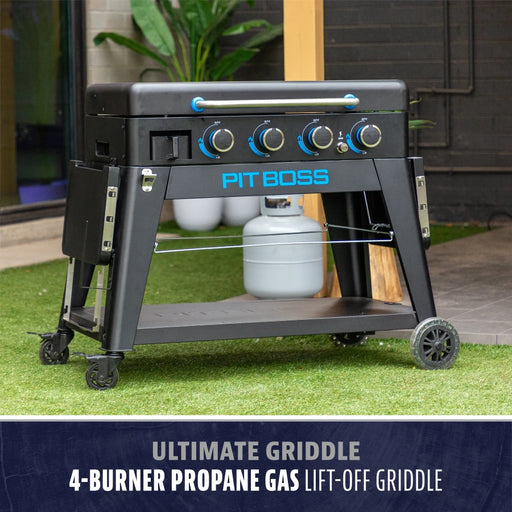 Pit Boss 4-burner propane gas griddle with lift-off top, black frame, blue accents, and wheeled base for easy mobility.