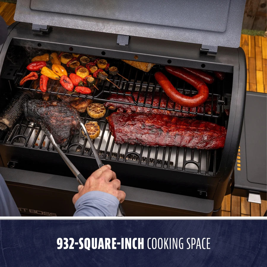 Charcoal grill with 932-square-inch cooking space, cooking ribs, sausage, and vegetables.