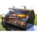 Black Pro Series multi-level grill with various meats and vegetables cooking.