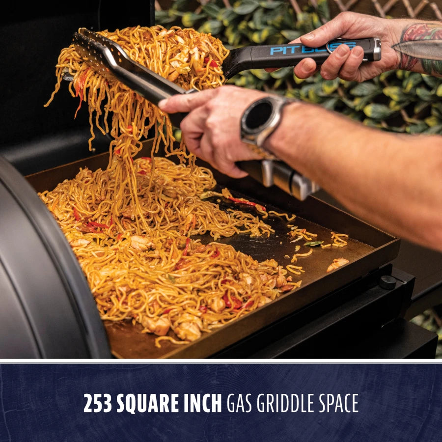 Black gas griddle with 253 square inch cooking space, cooking noodles.