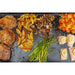 Ceramic griddle top on Pit Boss Grills 4-burner upgrade, showcasing cooked meats, vegetables, and sides.